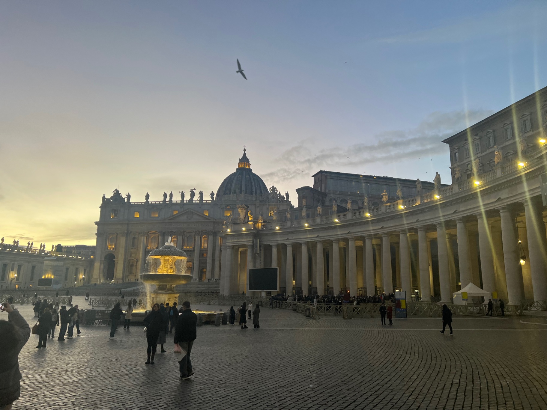 Rome — St. Peter's Basilica and the colonnade at dusk.