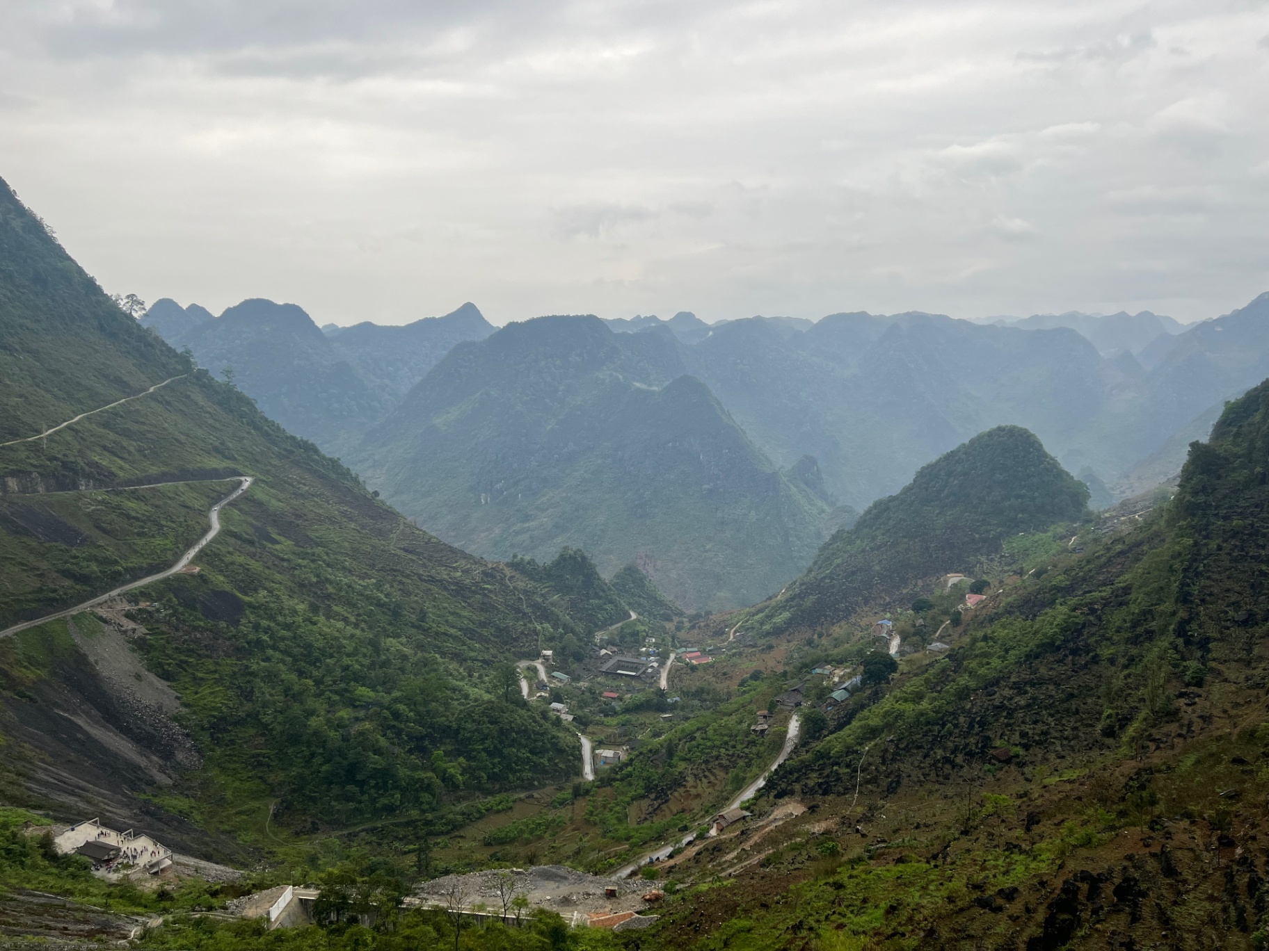 Ha Giang — Switchbacks carving down to a village in the valley floor.