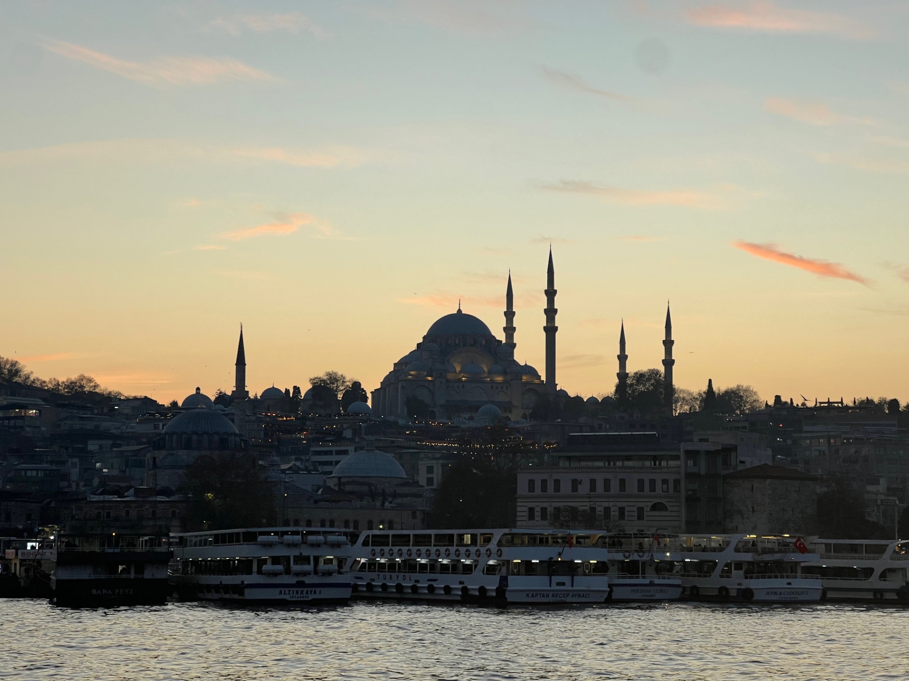 Istanbul — Süleymaniye Mosque silhouetted over the Golden Horn at sunset.