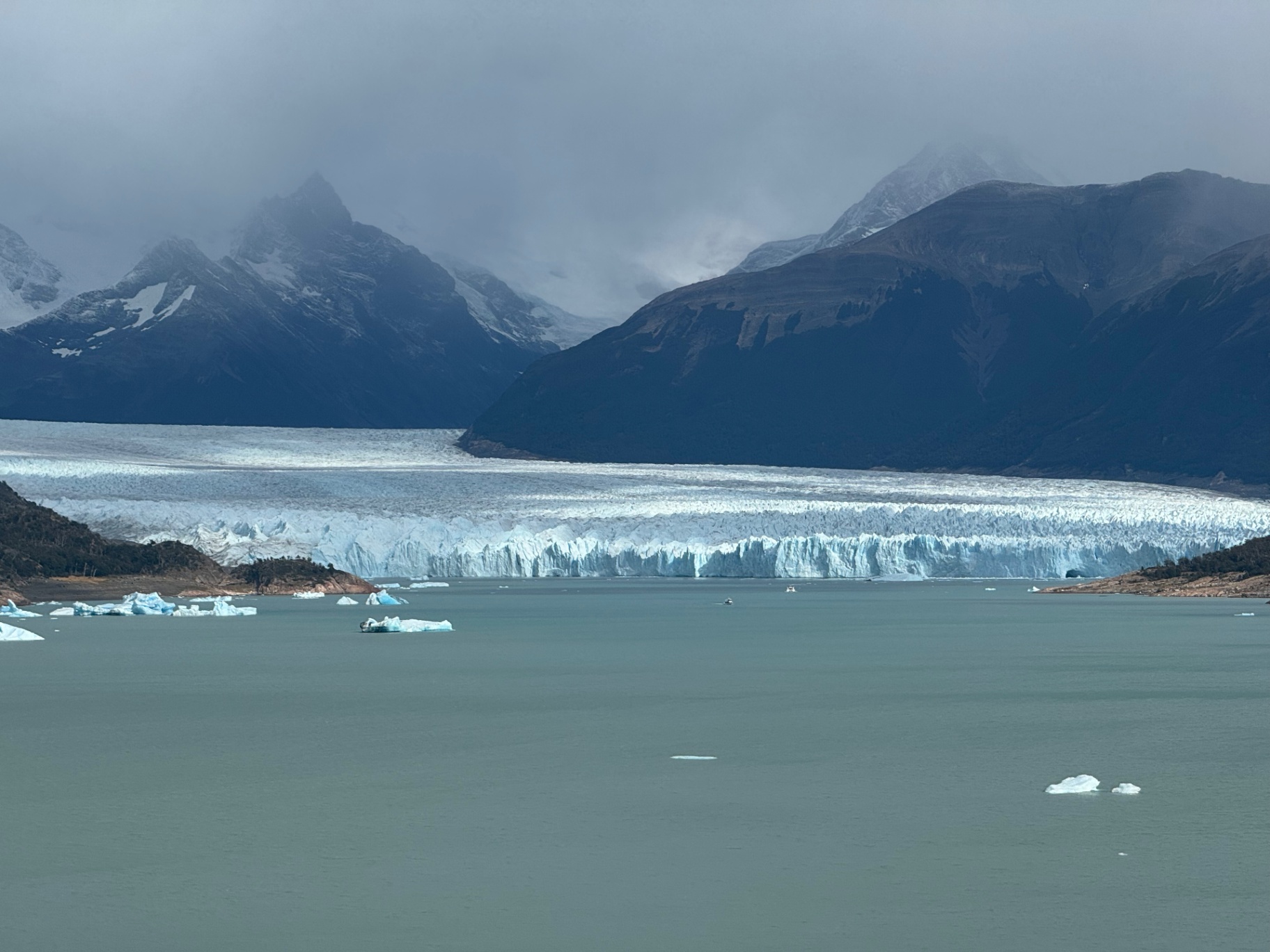 El Calafate — Perito Moreno's ice wall under brooding clouds.