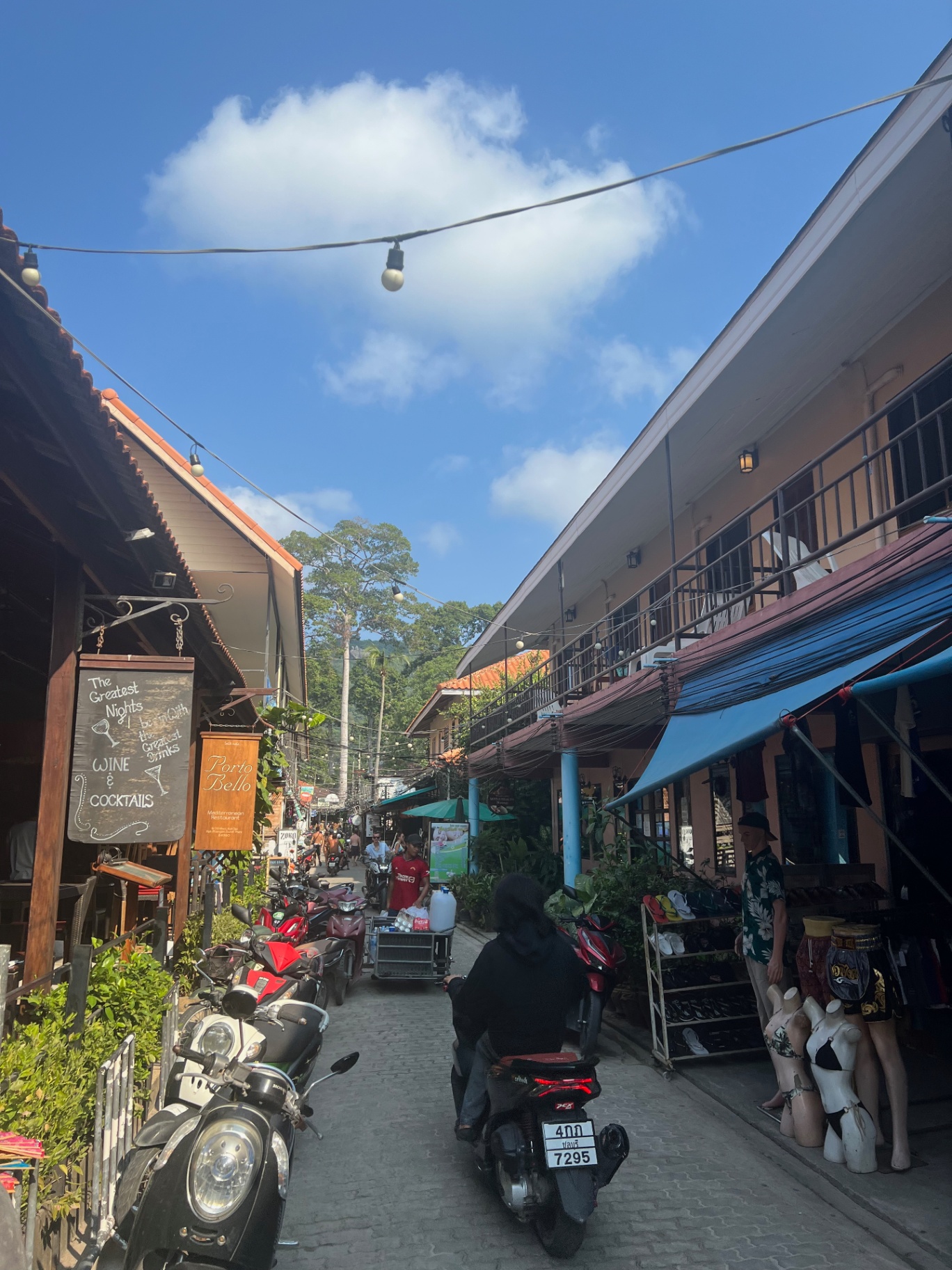 Ko Tao — Sairee village backstreets buzzing with scooters at midday.