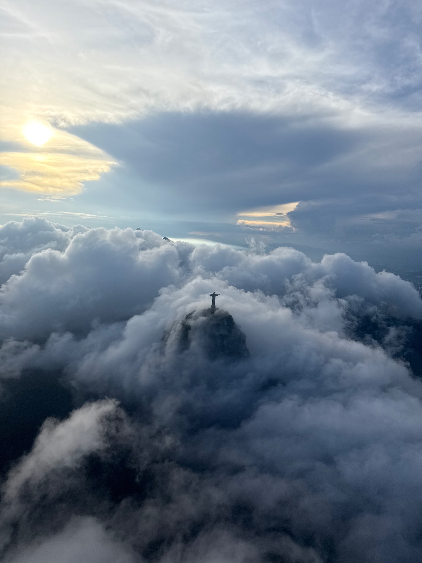 Rio de Janeiro — Sunrise above Corcovado, the statue floating in cloud.