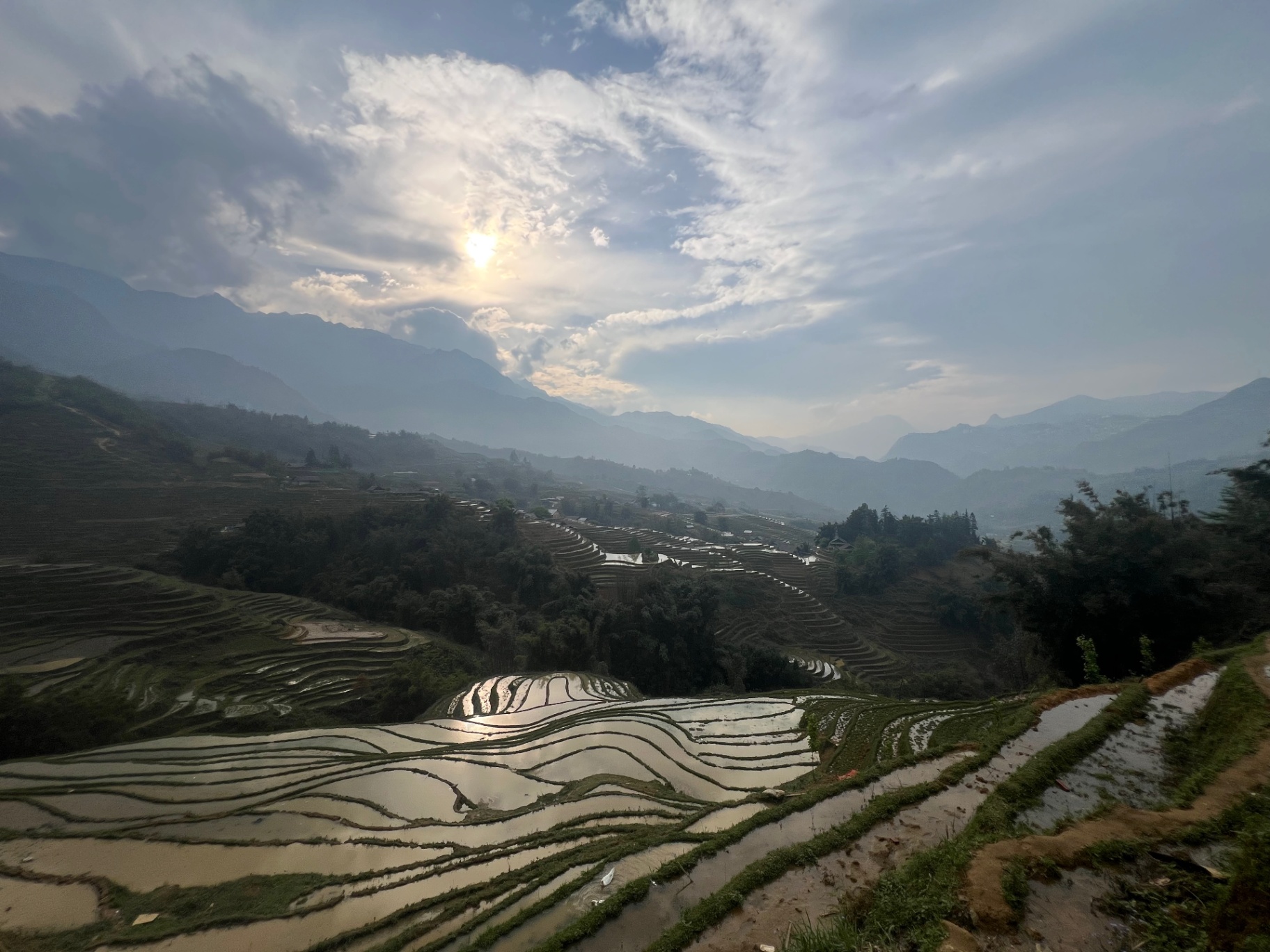 Sa Pa — Flooded terraces catching the late afternoon sun like mirrors.