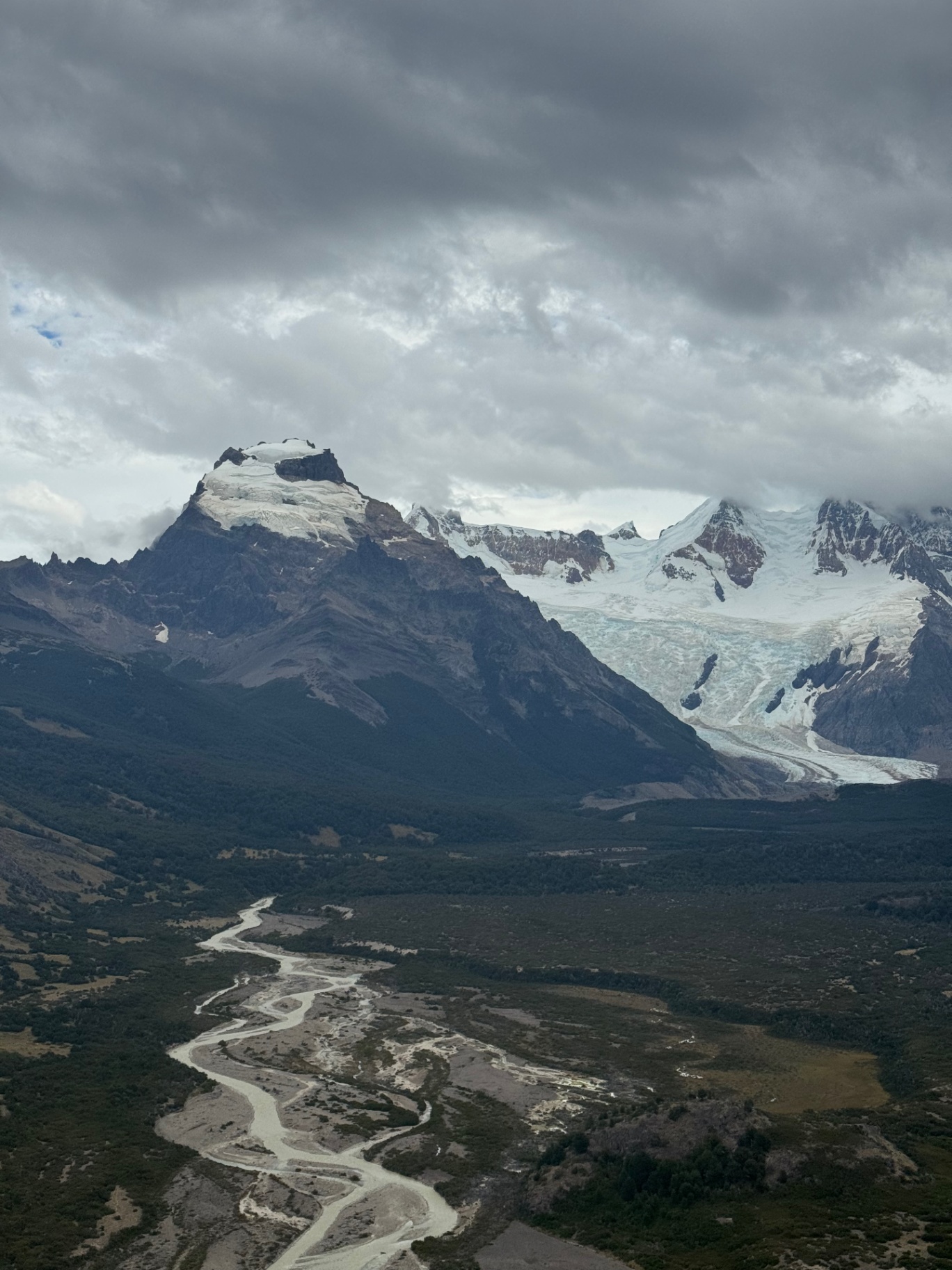 El Chalten — A hanging glacier above the braided river valley.