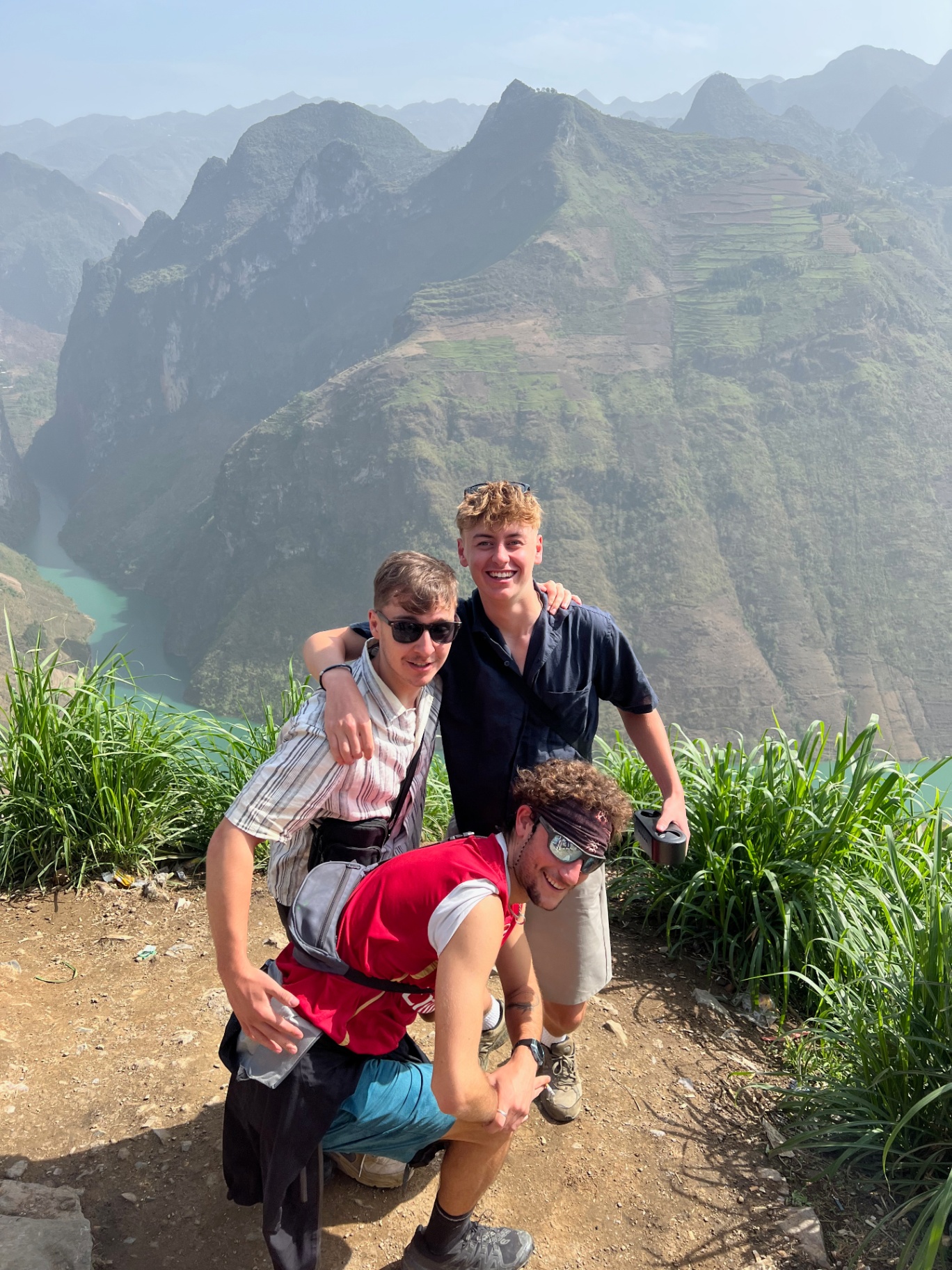 Ha Giang — The crew posing above the Nho Que river canyon.
