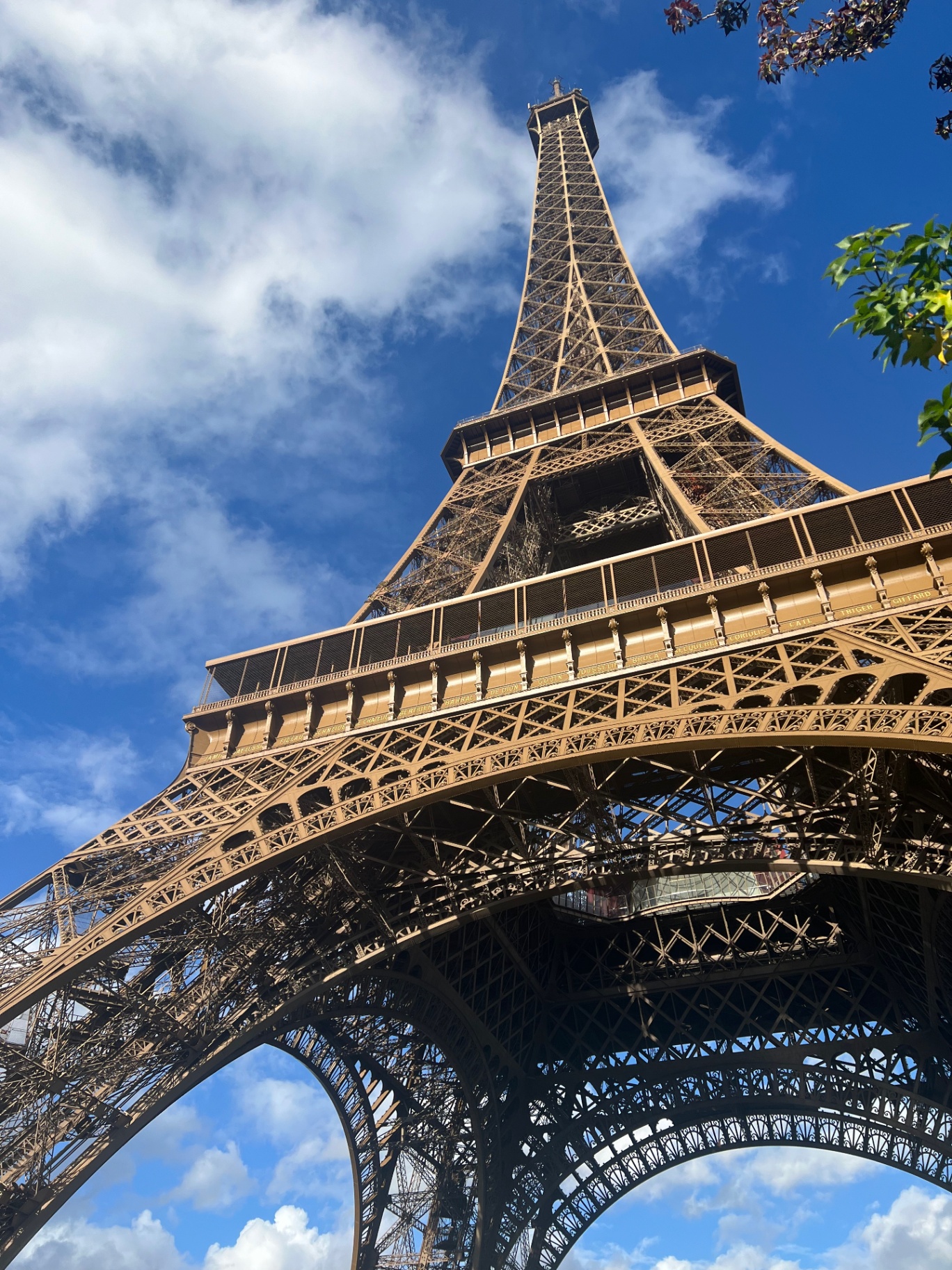 Paris — Looking up the Eiffel Tower against a summer sky.