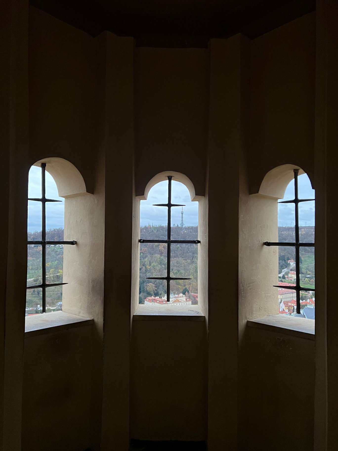 Prague — Petřín Tower framed through castle tower windows.