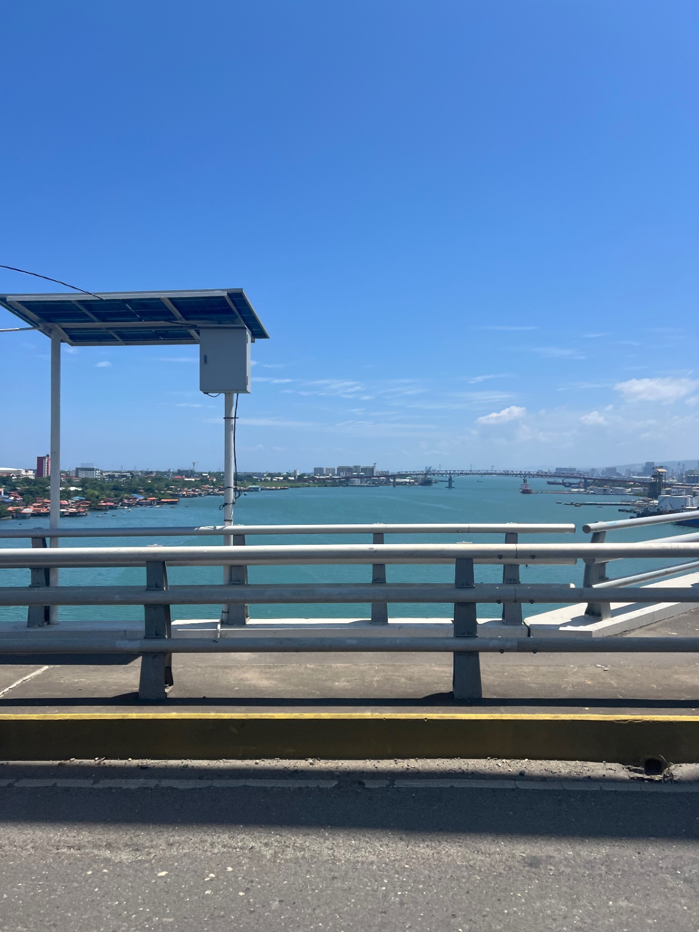 Cebu — Mactan Channel under a hard tropical blue sky.
