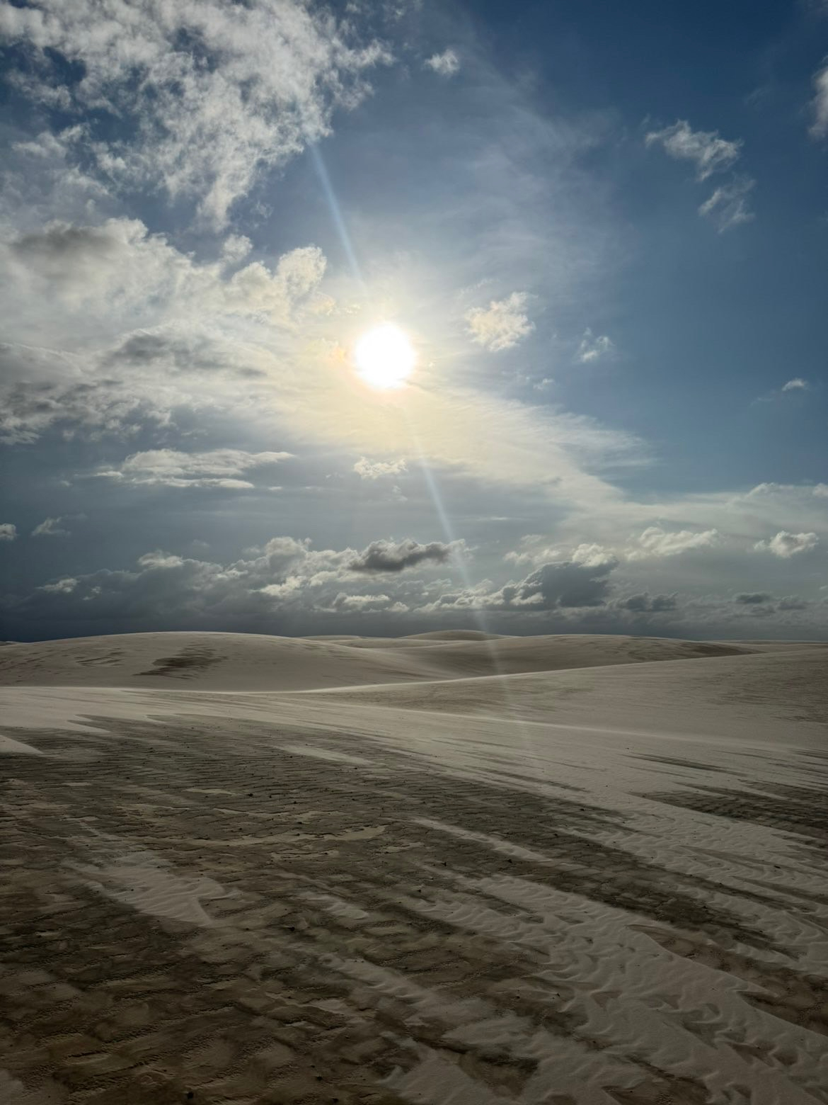 Lencois Maranhenses — Sunlight cutting across rolling dunes after the rain.