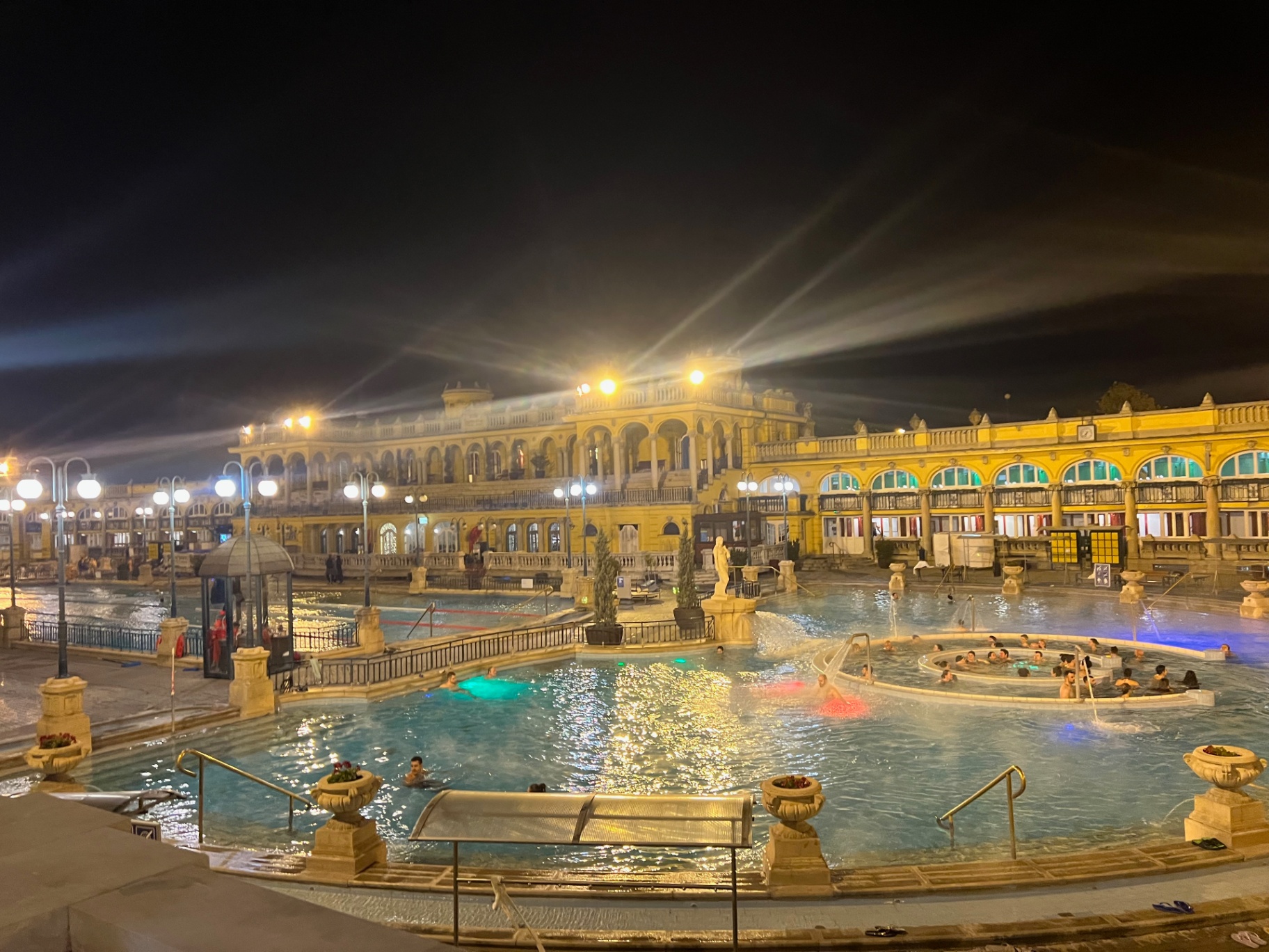 Budapest — Steam rising over Széchenyi thermal baths at night.