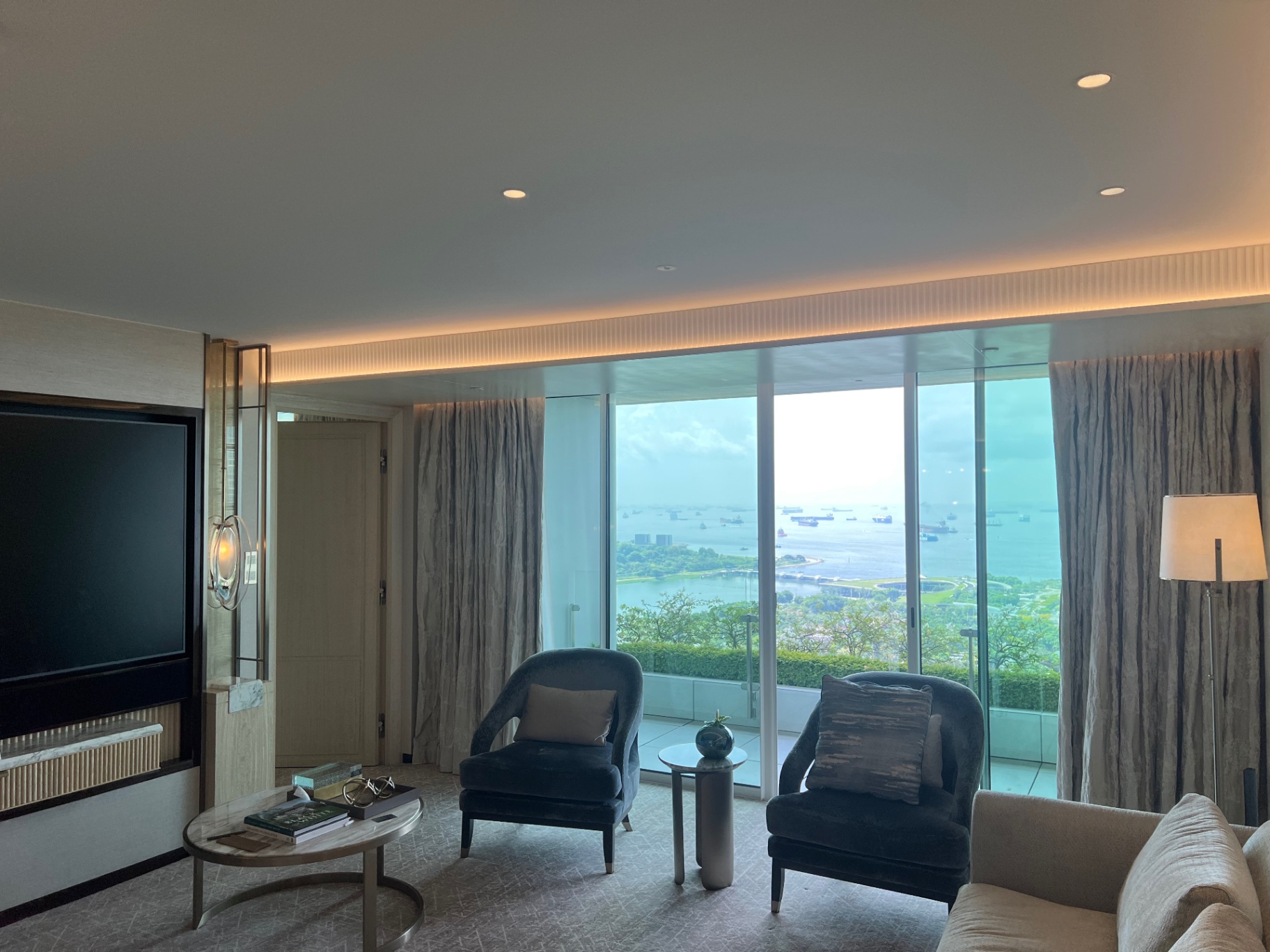Singapore — Quiet hotel-room view over the harbor, softened by morning haze.