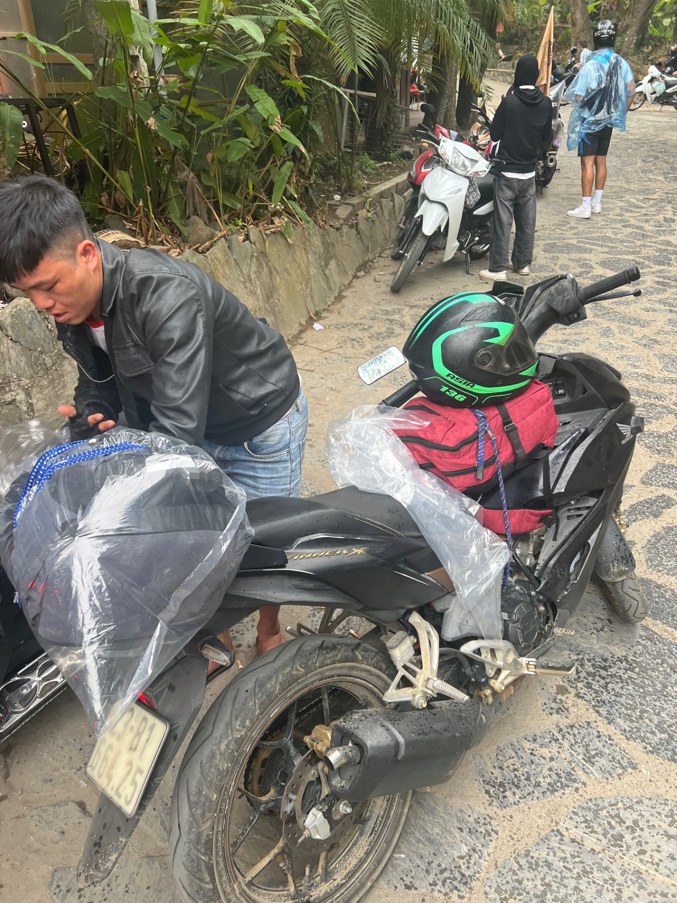 Ha Giang — Bikes loaded up and wrapped in plastic before the rain.