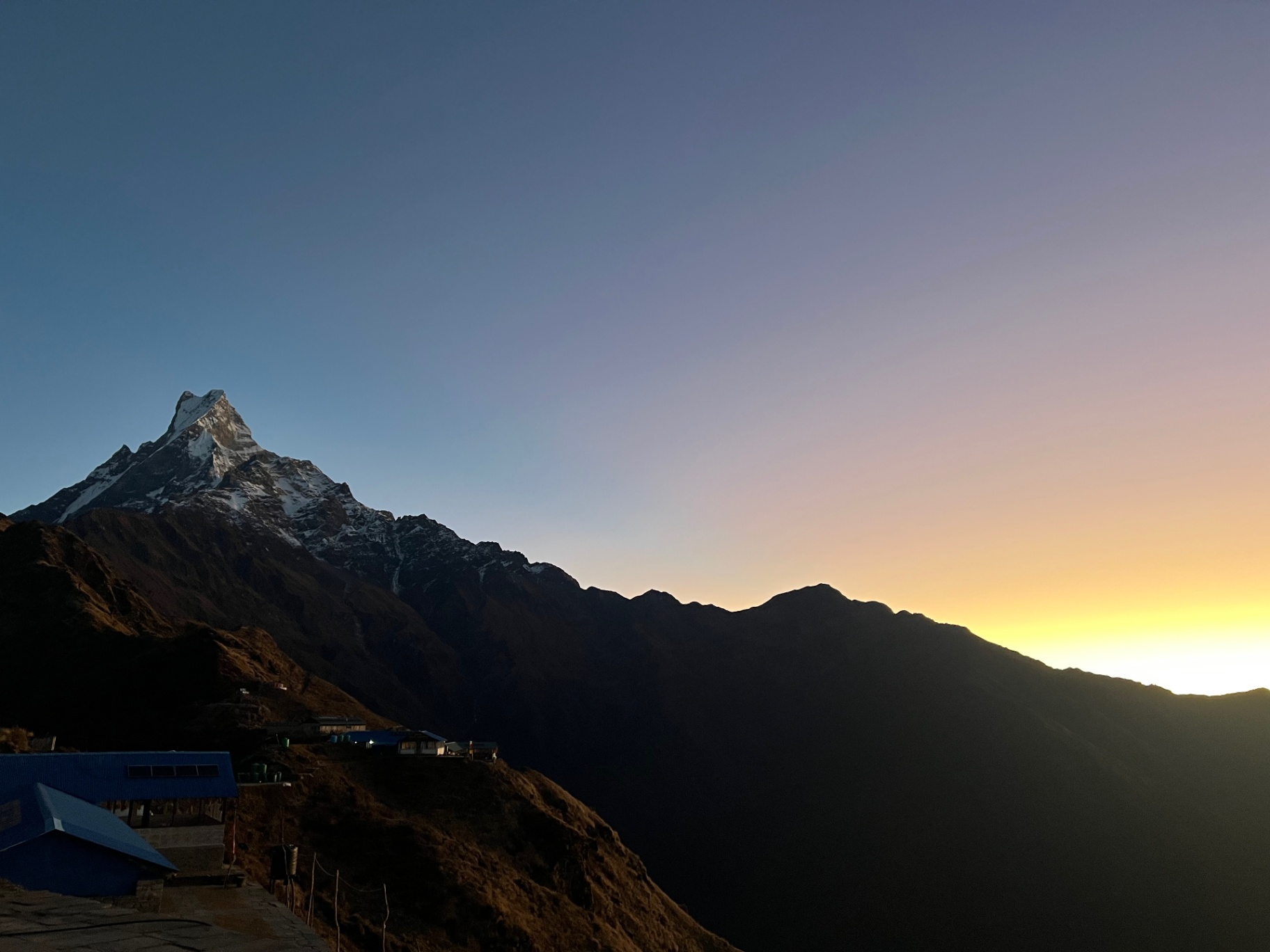 Pokhara — Machhapuchhre silhouetted at dusk, the last light burning off the ridge.