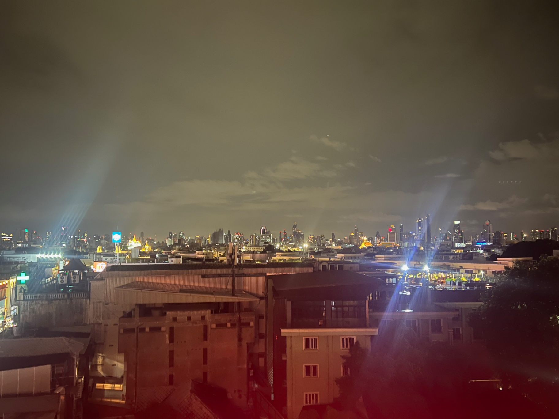 Bangkok — Bangkok skyline glittering under heavy night clouds.