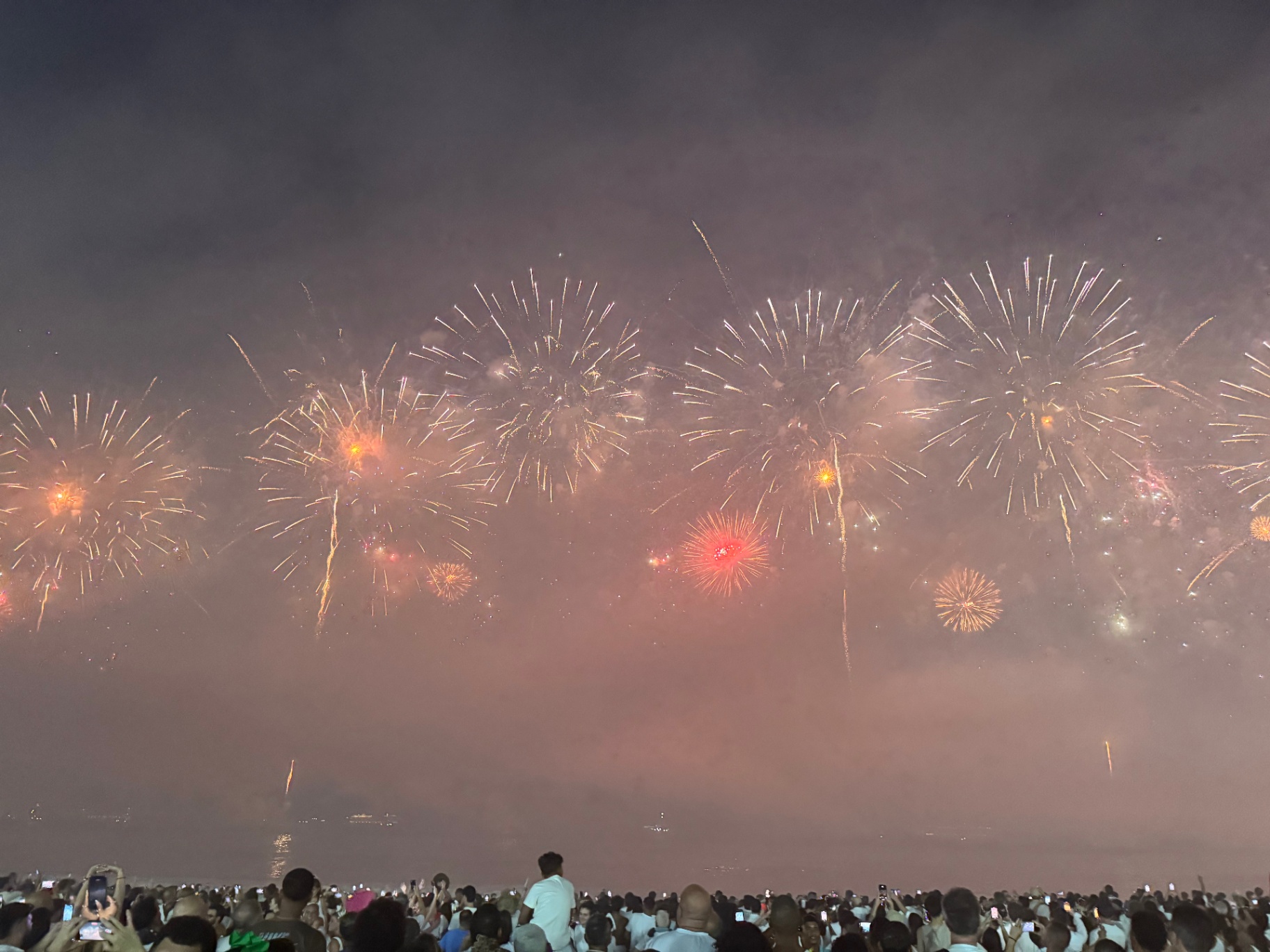 Rio de Janeiro — Golden fireworks crowning midnight on Copacabana beach.