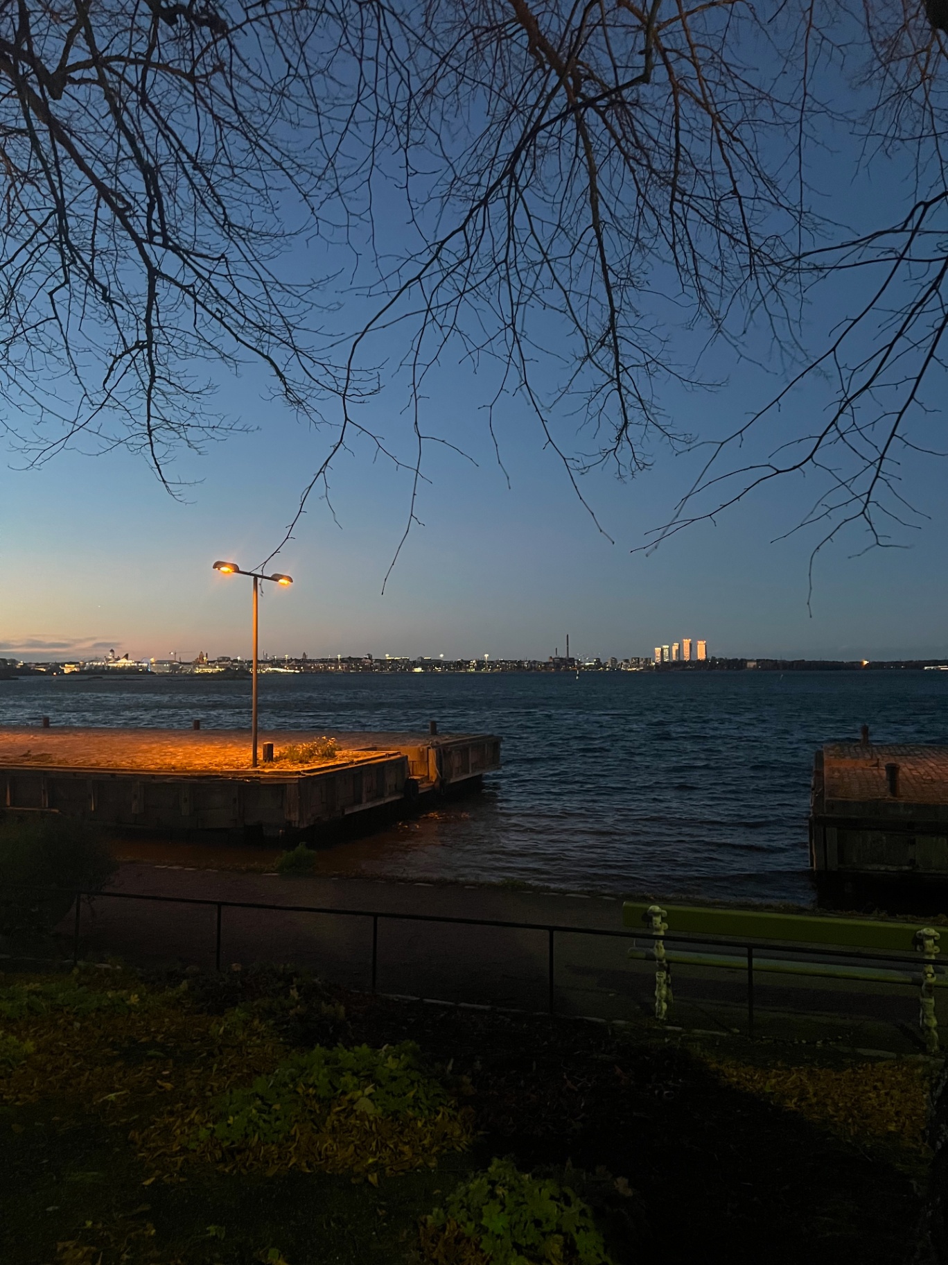 Helsinki — Dusk over the bay, city lights on the horizon.