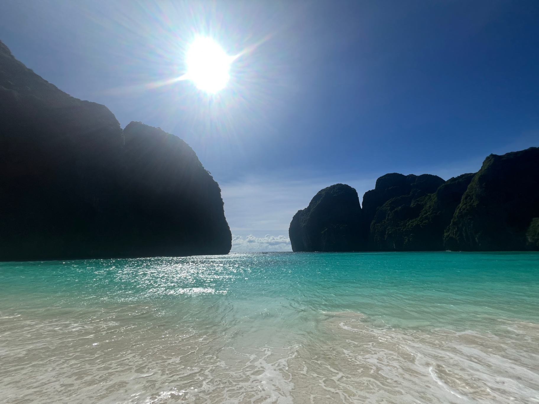 Phi Phi Island — Sun bursting over the karsts at Maya Bay.
