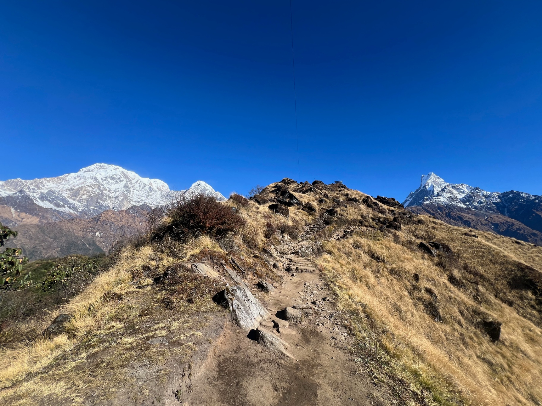 Pokhara — Final ridge push to High Camp with Annapurna and Machhapuchhre flanking the trail.