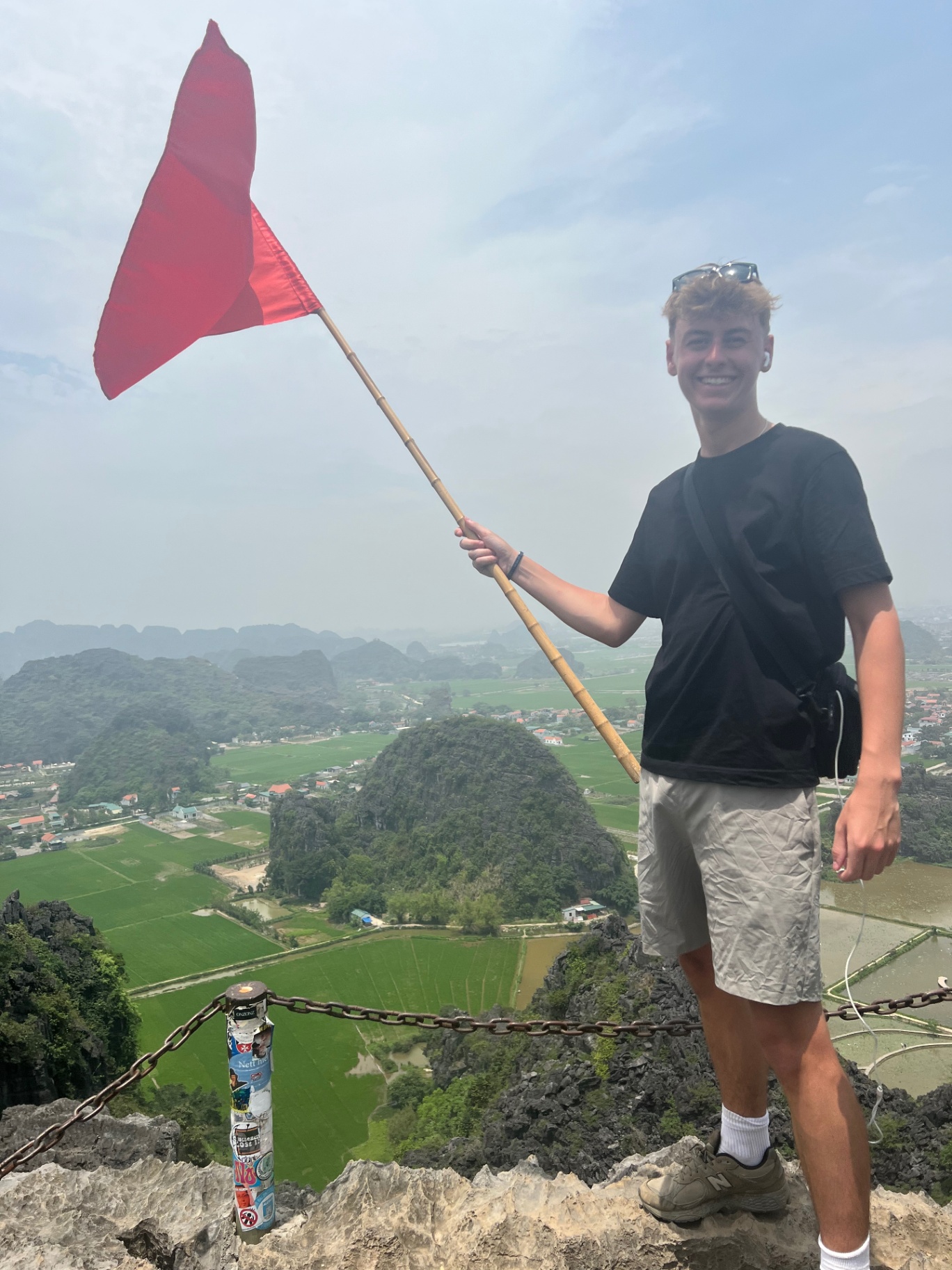 Ninh Binh — Red flag raised over the rice fields from Mua Cave peak.