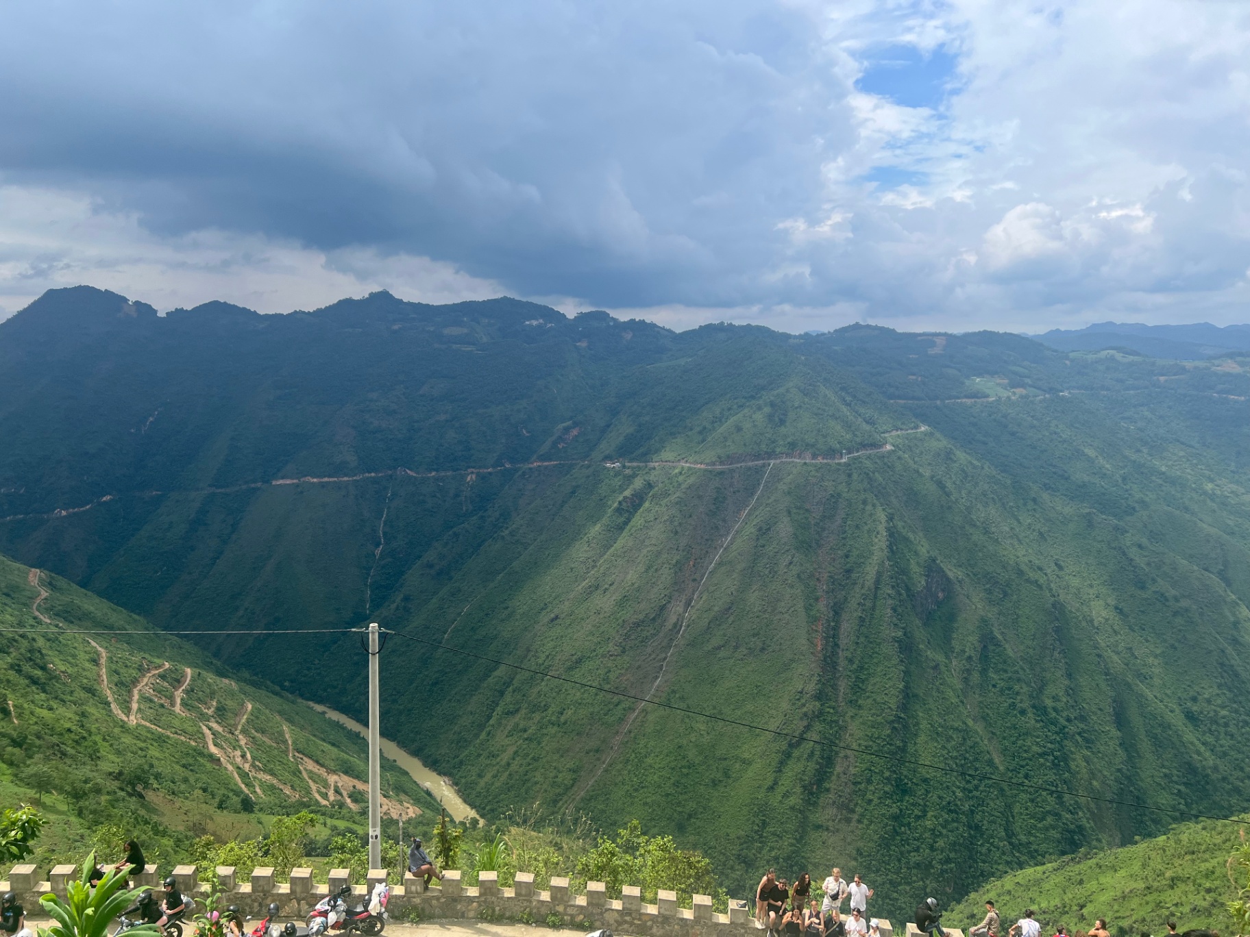 Ha Giang — Karst peaks fading into the haze above a valley road.