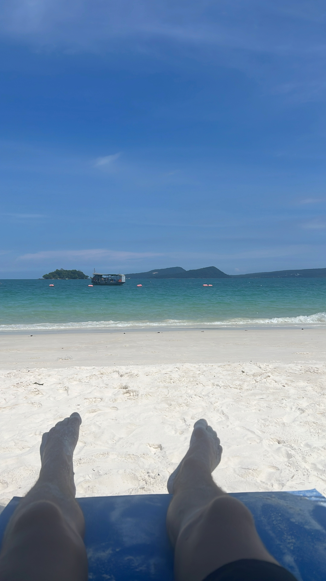 Koh Rong — Feet up on the sand at Saracen Bay, Koh Rong Samloem.
