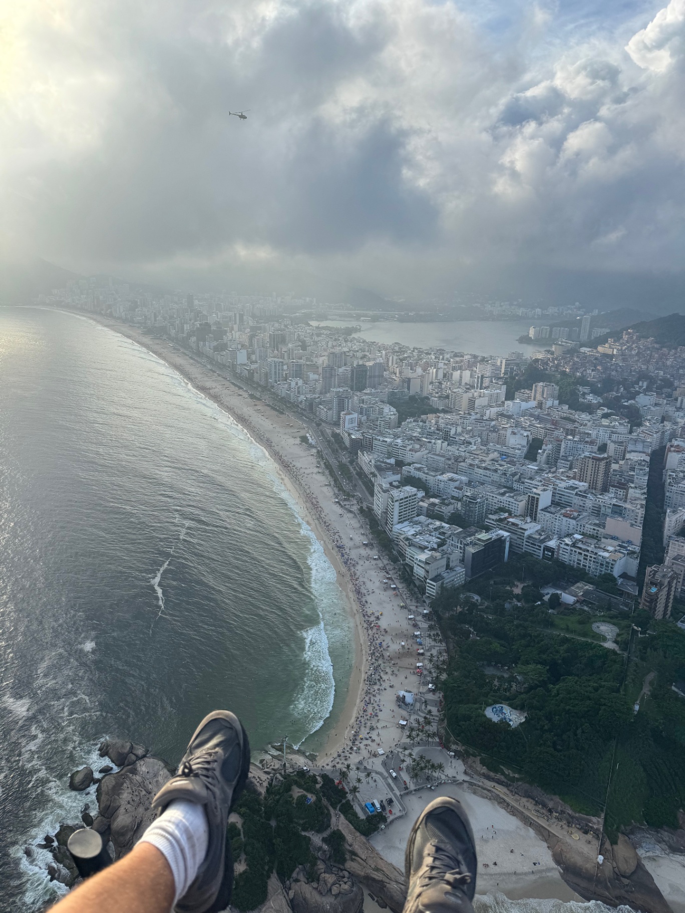 Rio de Janeiro — Feet dangling over Ipanema from the top of Pedra do Telégrafo.