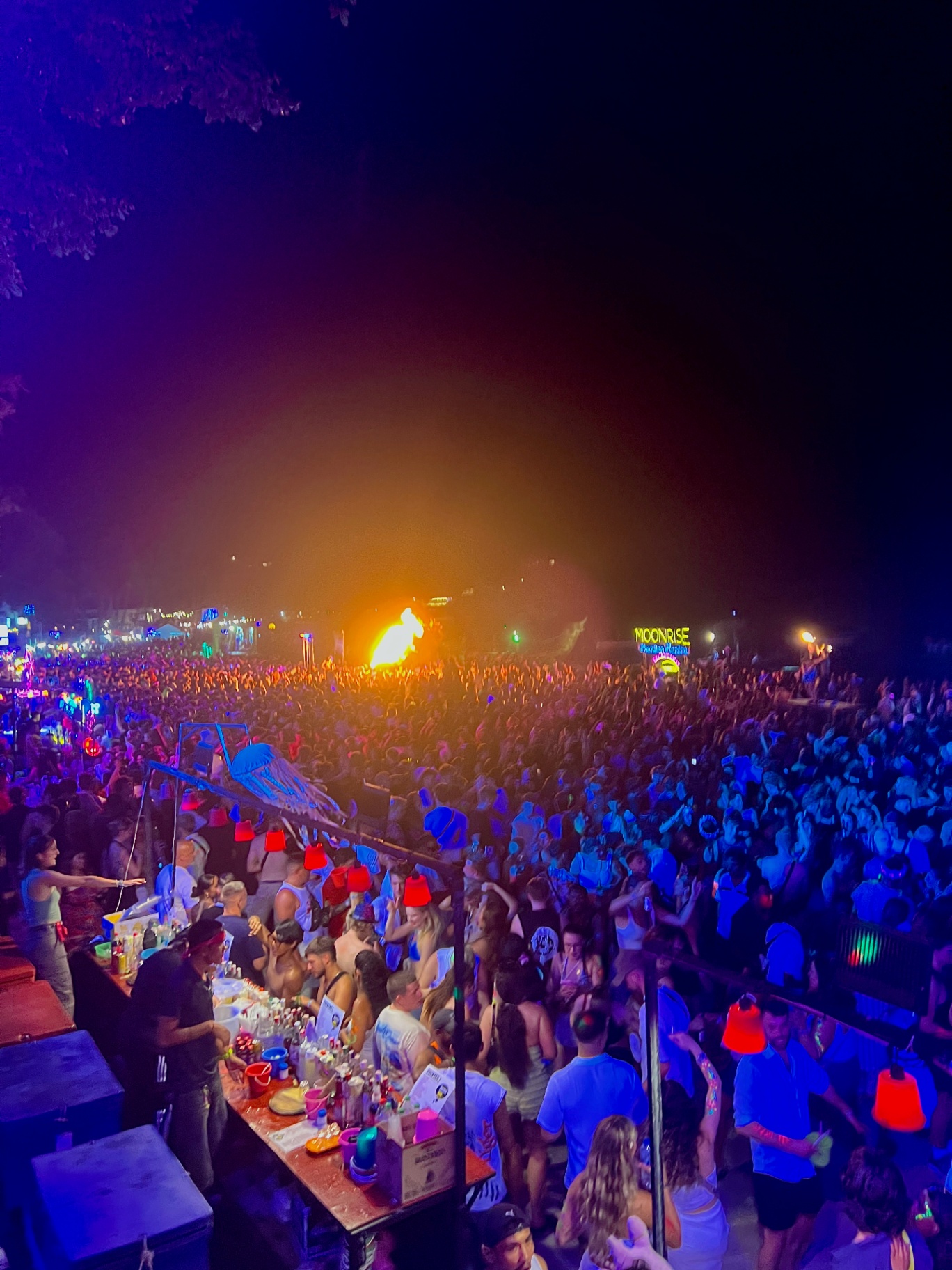 Ko Pha Ngan — Full Moon Party crowd bathed in neon under the fire show.