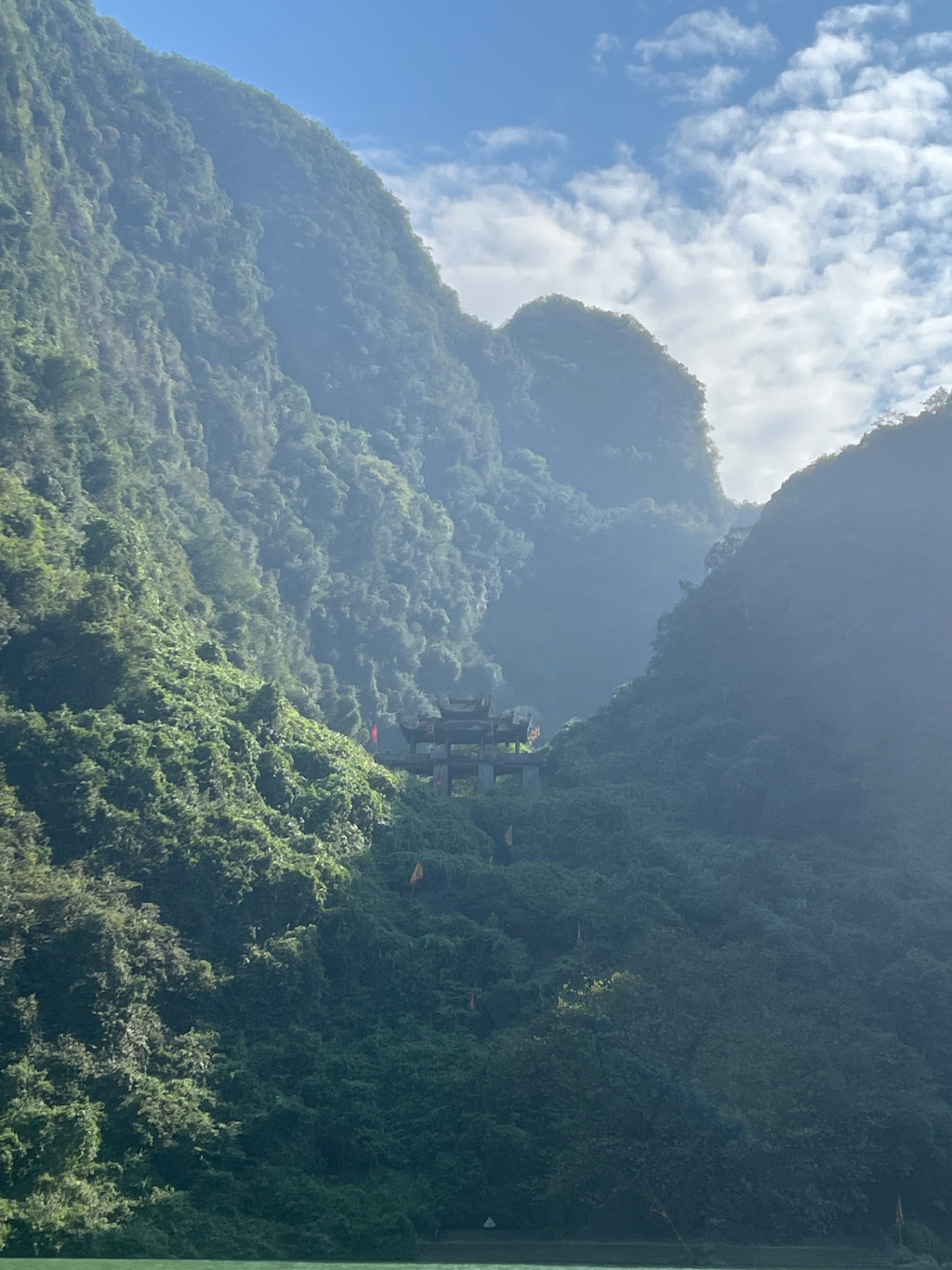 Ninh Binh — A temple tucked into the karst cliffs above the Trang An river.