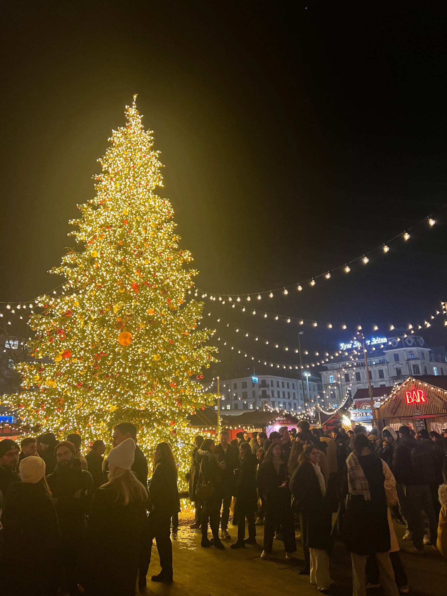 Zurich — A glowing Christmas tree at Zurich's festive market.