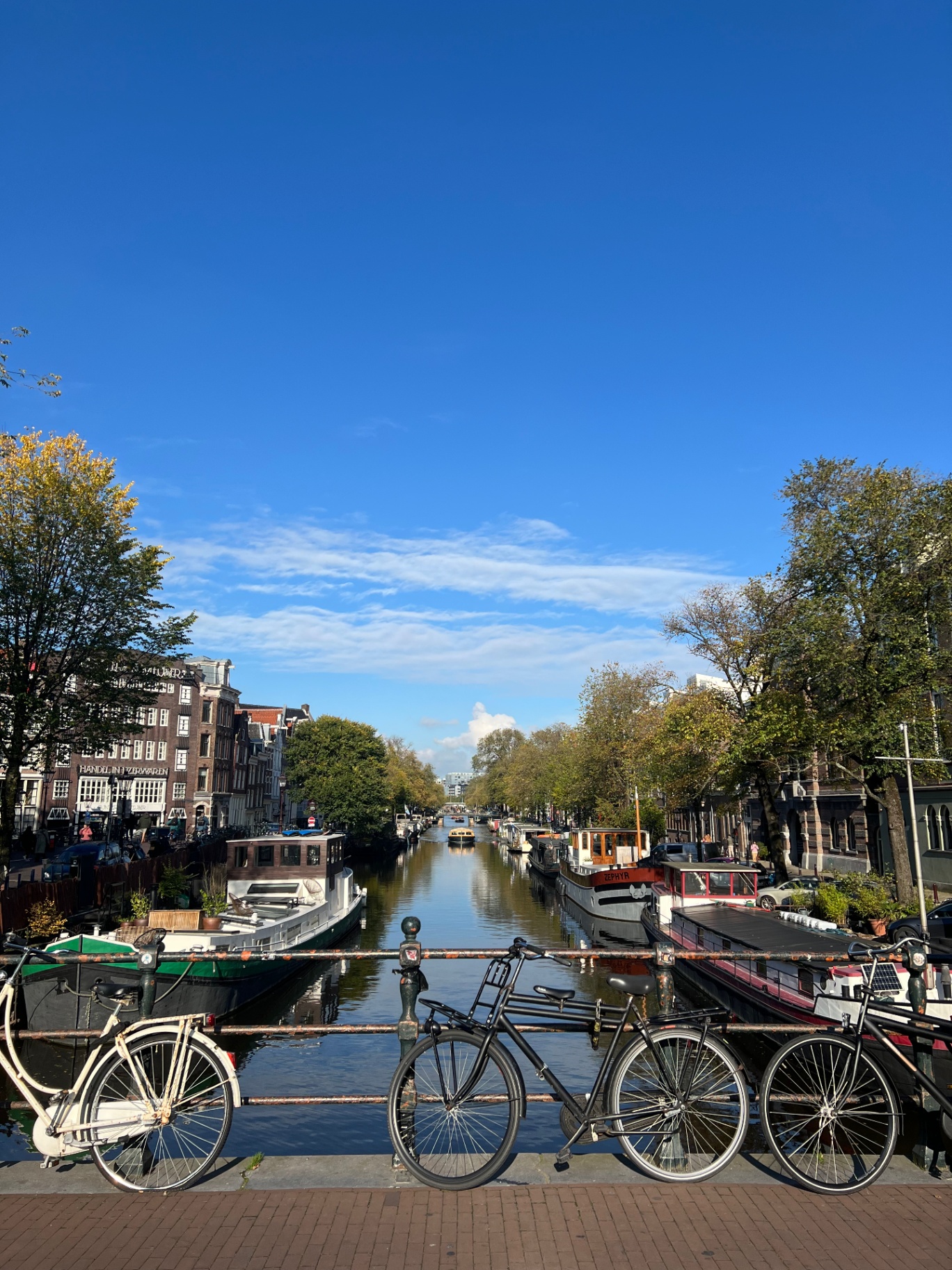 Amsterdam — Bicycles on the bridge, houseboats below.