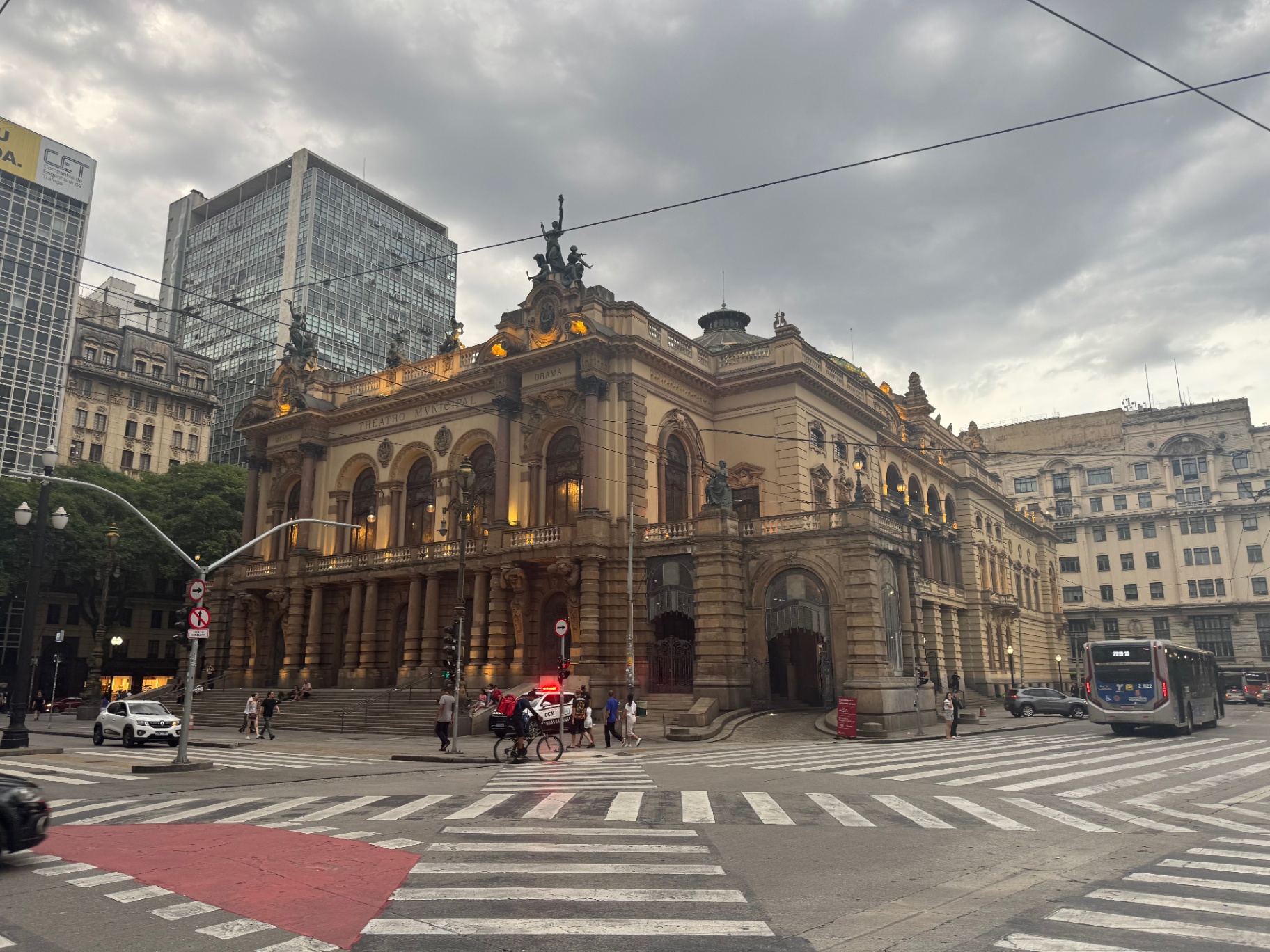 Sao Paulo — Theatro Municipal glowing under a stormy downtown sky.