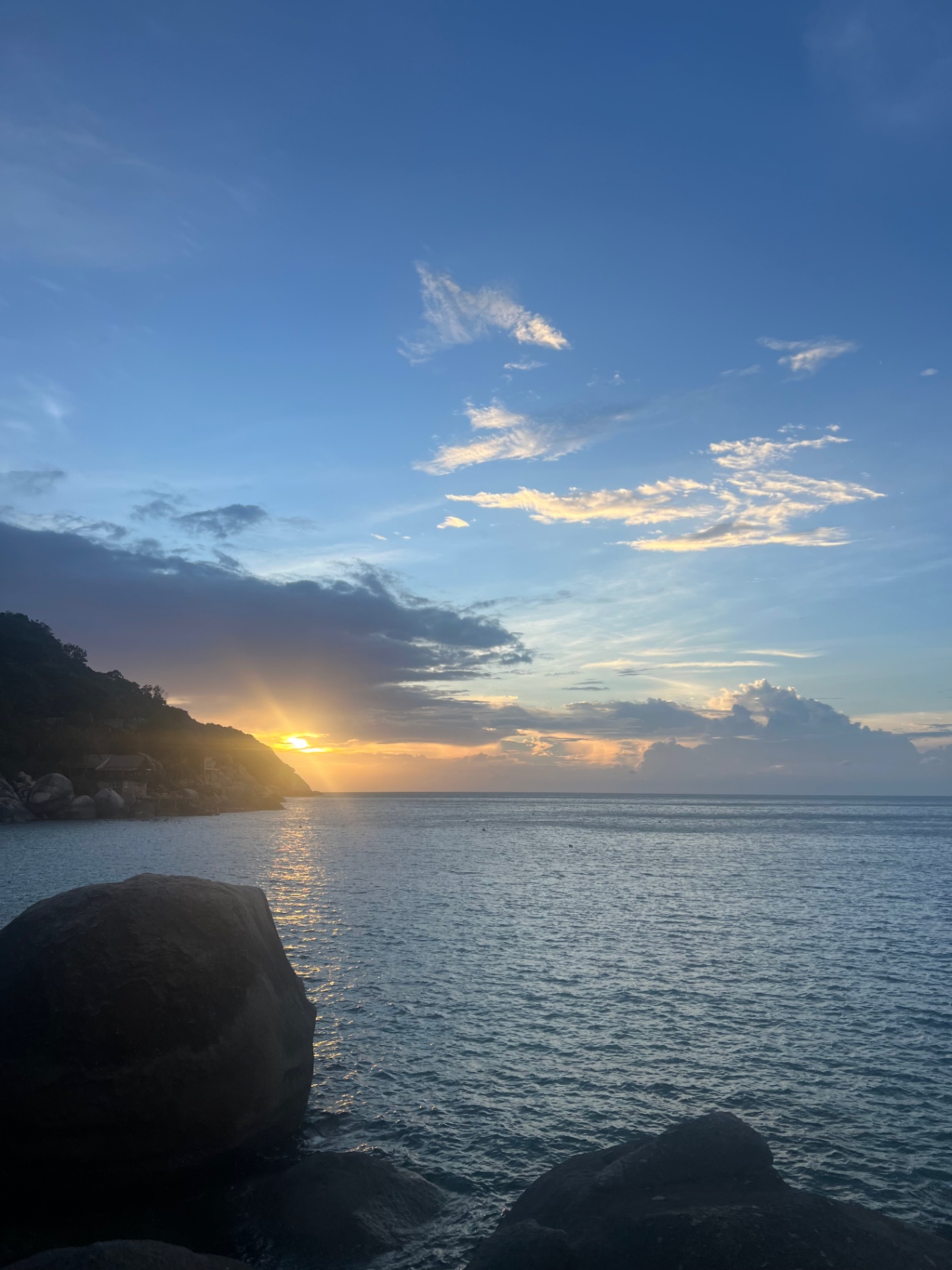 Ko Tao — Soft sunrise breaking over the headland at a quiet bay.