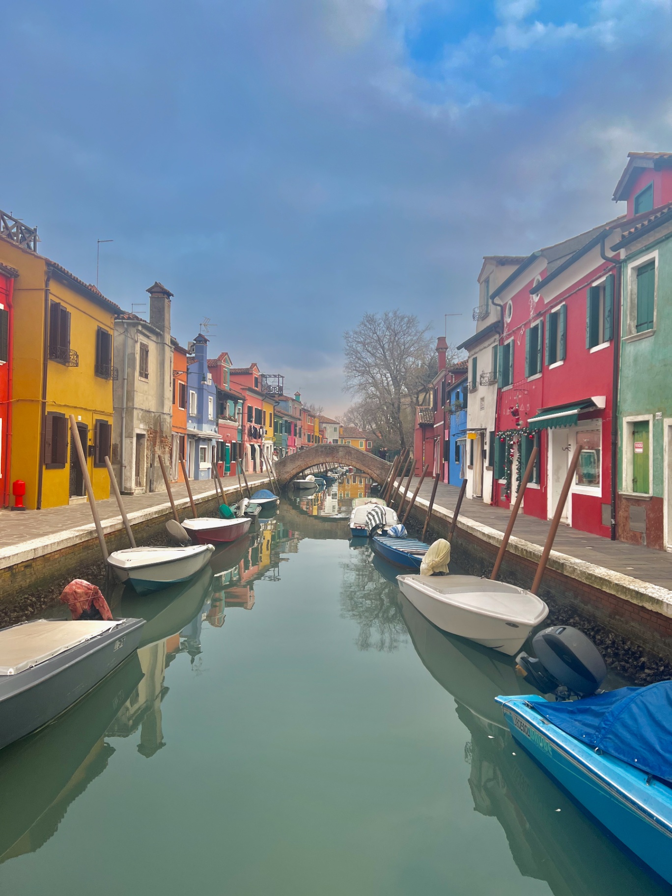 Venice — Burano's painted houses lining a quiet canal.