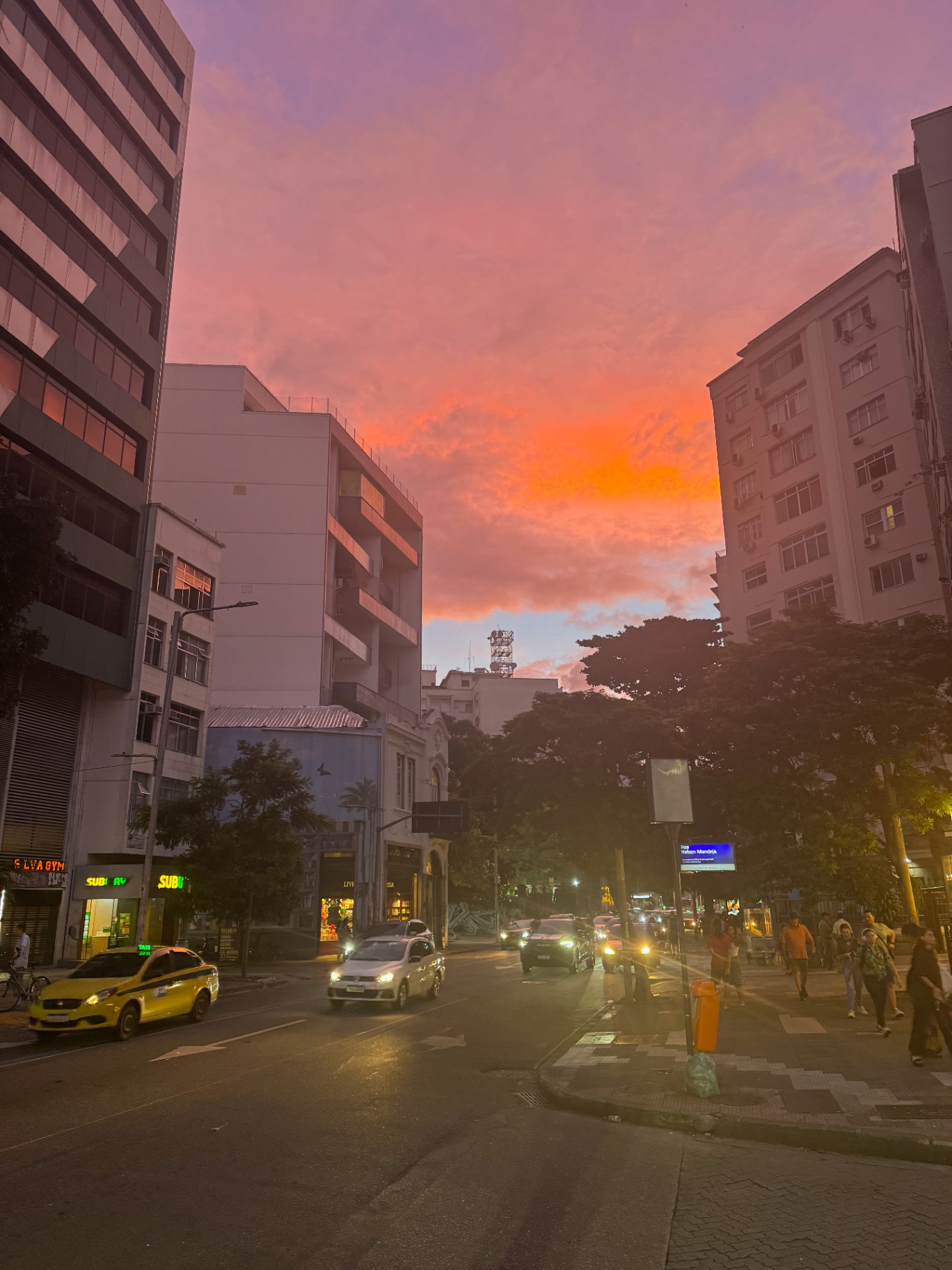 Rio de Janeiro — A burning pink sky over a Rio street at dusk.